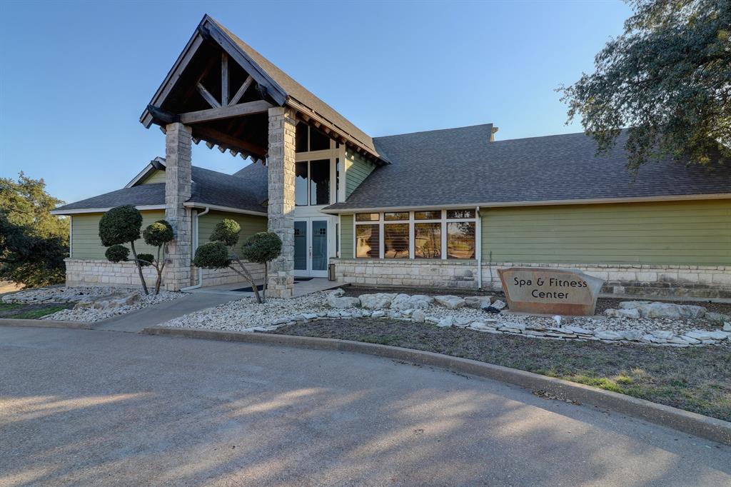 1213 Overlook Court Whitney, TX 76692 - Photo 25 of 29 a front view of a house with a yard and garage