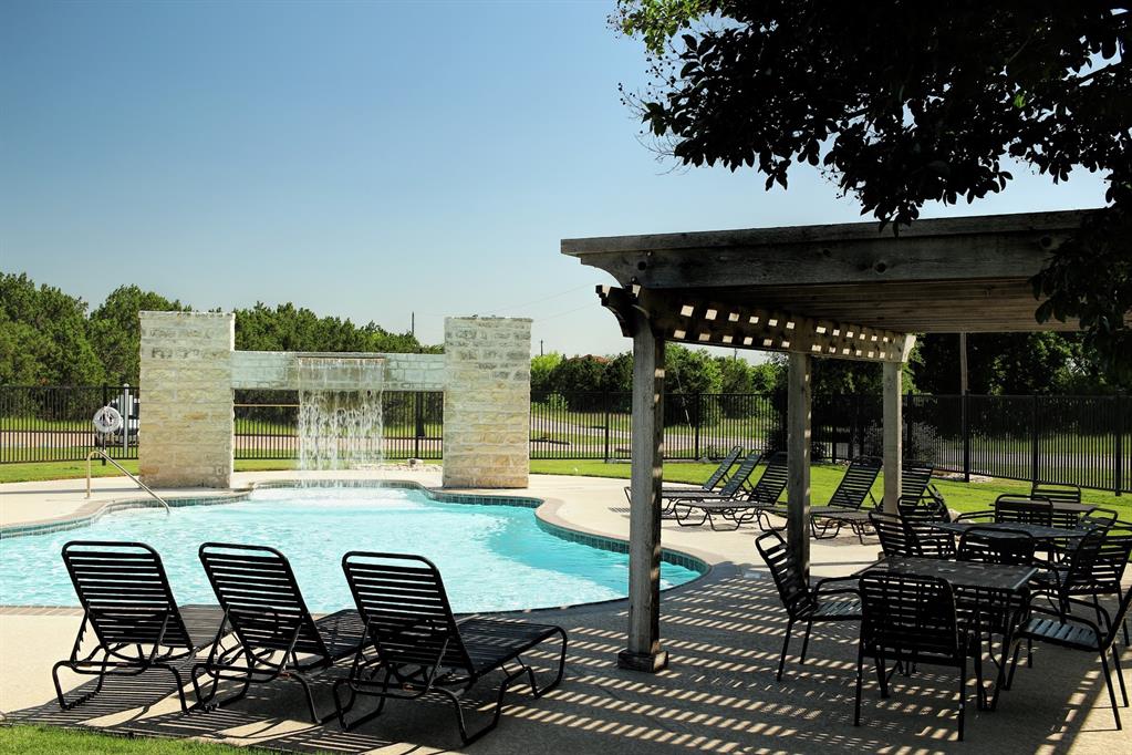 1213 Overlook Court Whitney, TX 76692 - Photo 10 of 29 a view of a patio with table and chairs potted plants with wooden floor and fence
