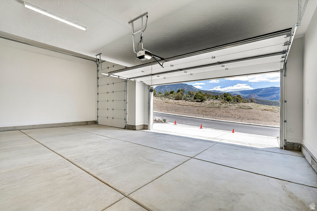 2862 South Mountain Rnch Road Cedar City, UT 84720 - Photo 42 of 64 Spacious garage with concrete flooring, automatic garage door opener, and overhead strip lighting
