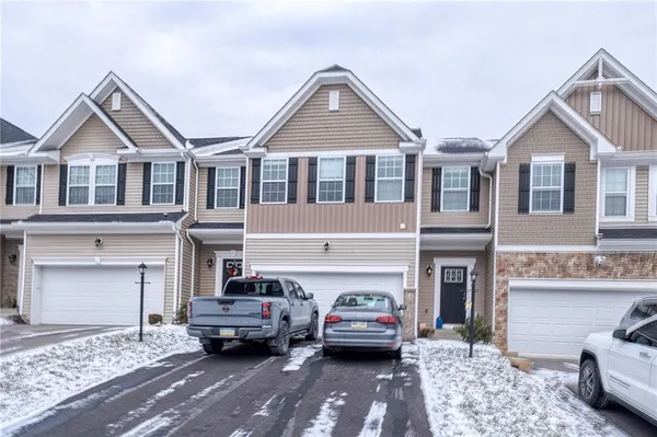 a front view of a house with parking space