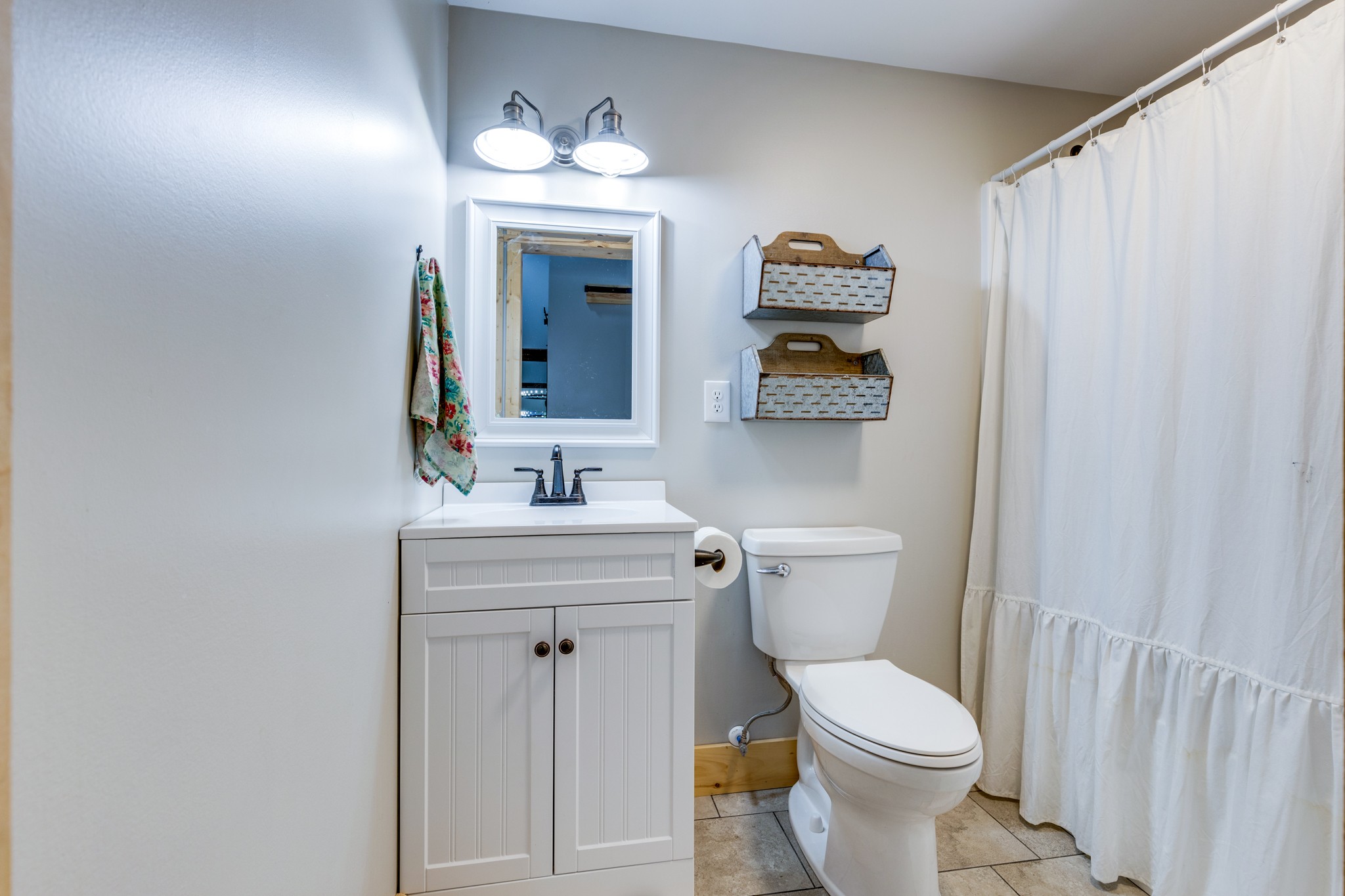 2790 9 Mile Ridge Road Duck River, TN 38454 - Photo 27 of 70 a bathroom with a toilet sink and mirror
