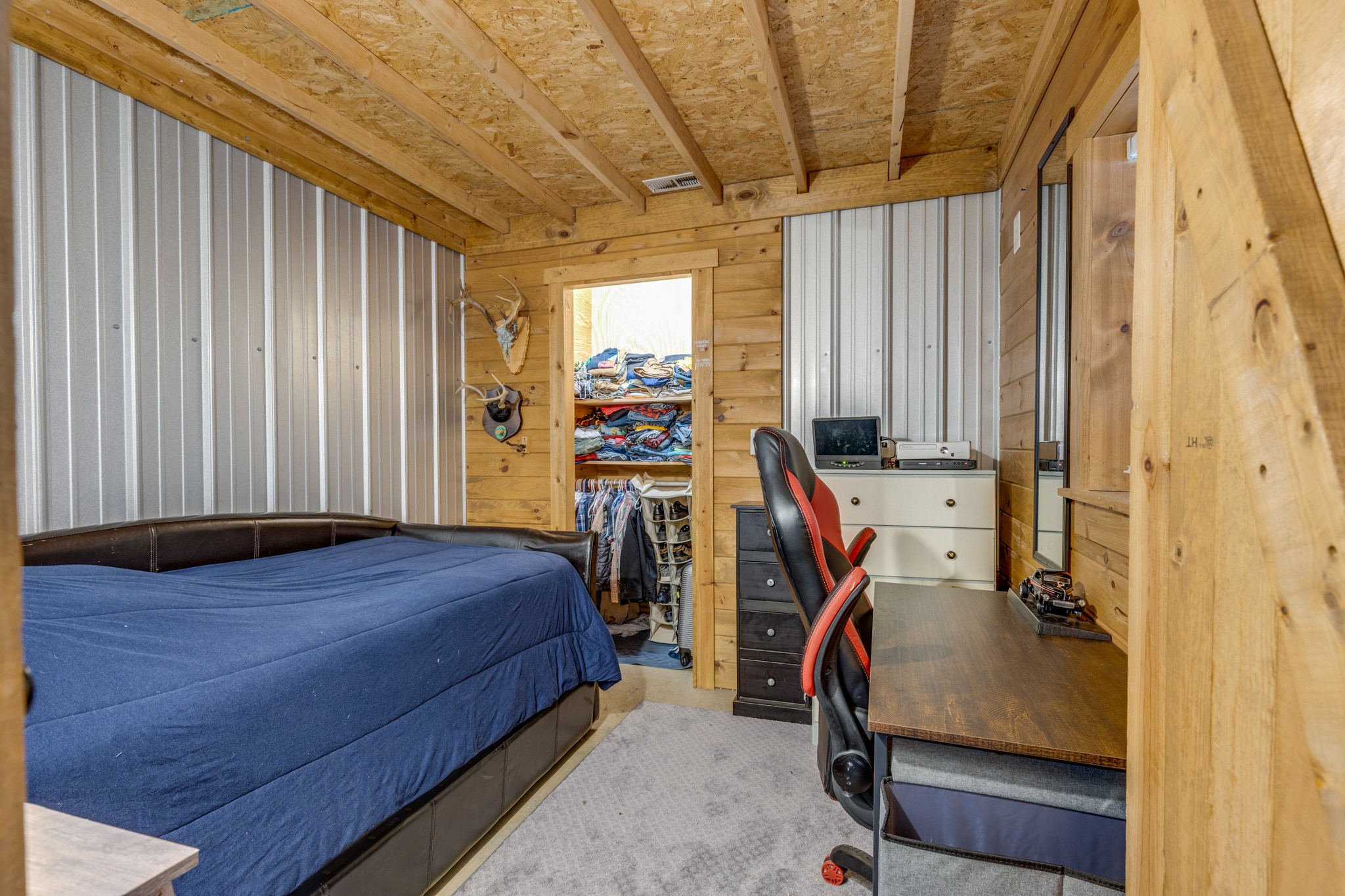 2790 9 Mile Ridge Road Duck River, TN 38454 - Photo 39 of 70 a bedroom with a bed and a chandelier