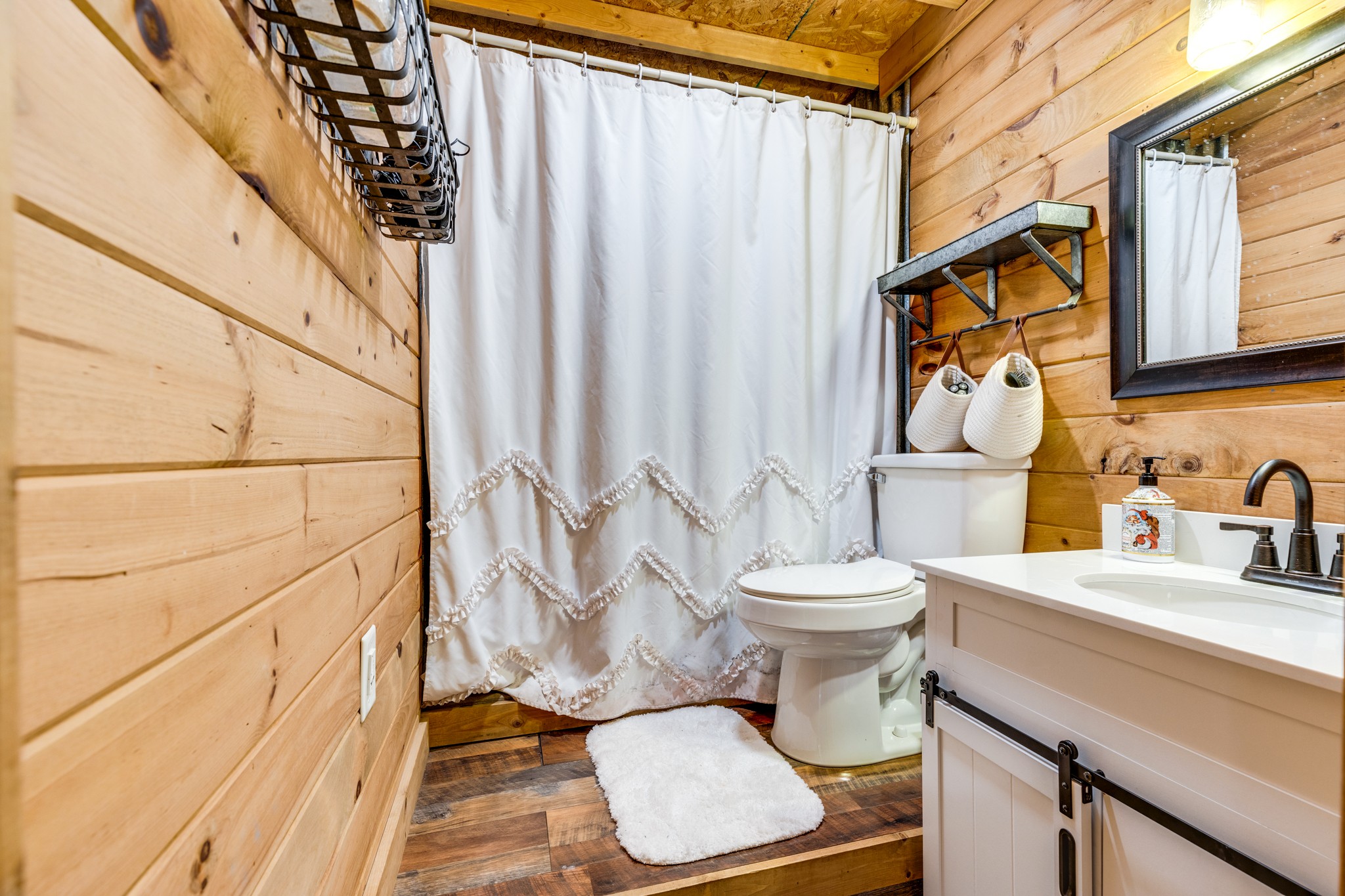 2790 9 Mile Ridge Road Duck River, TN 38454 - Photo 41 of 70 a bathroom with a sink a toilet and shower curtain