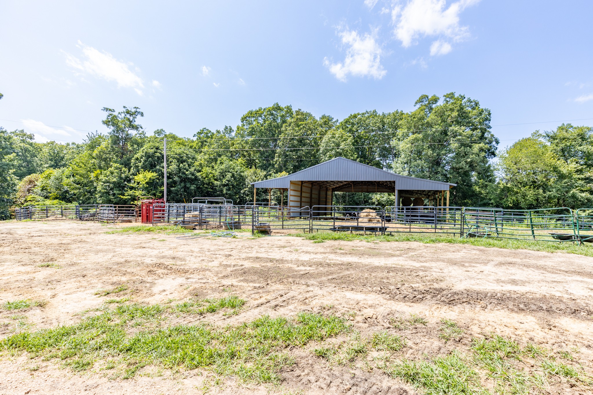 2790 9 Mile Ridge Road Duck River, TN 38454 - Photo 50 of 70 a view of a swimming pool with a table and chairs under an umbrella