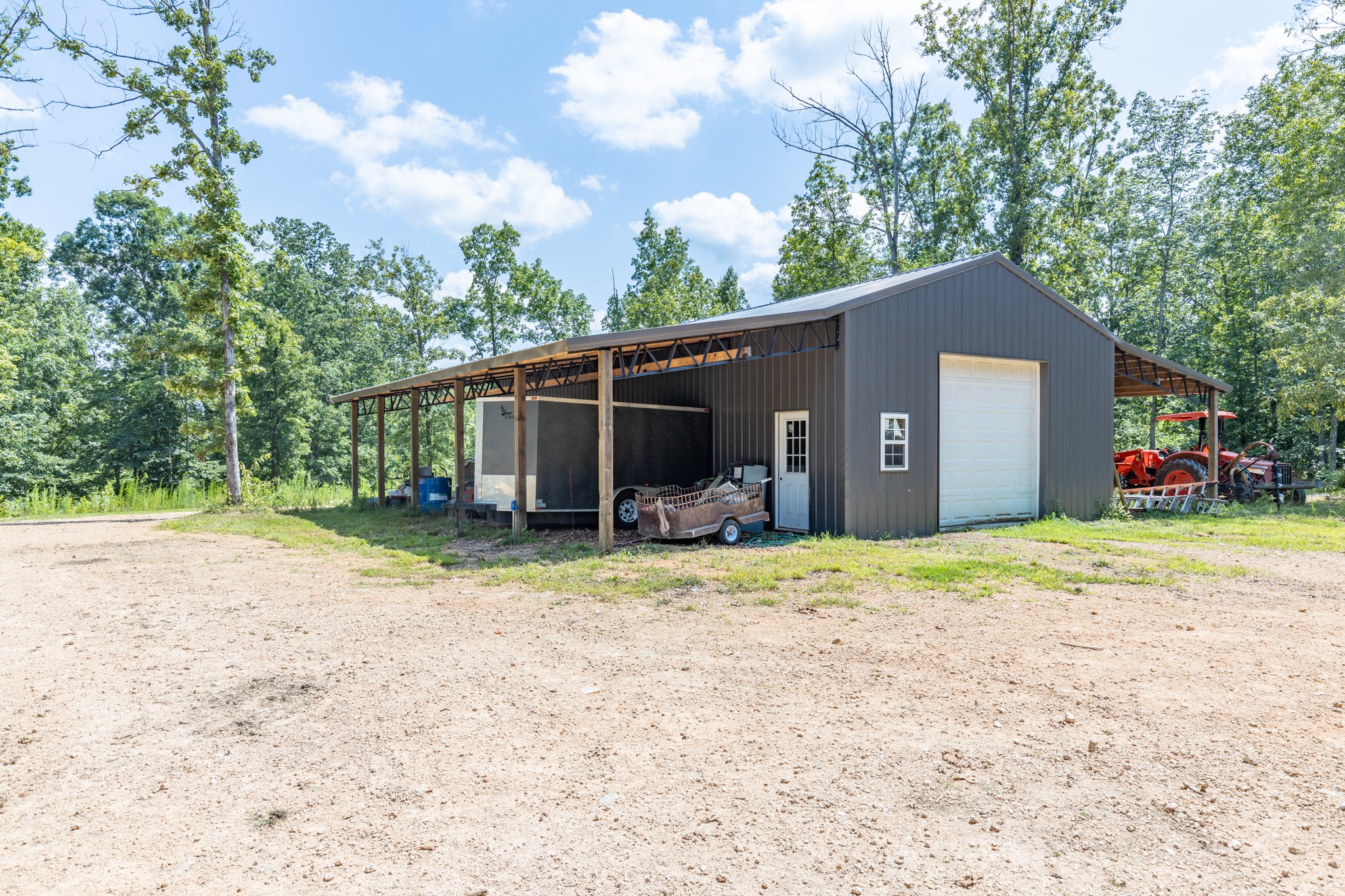2790 9 Mile Ridge Road Duck River, TN 38454 - Photo 54 of 70 a backyard of a house with wooden fence and a large tree