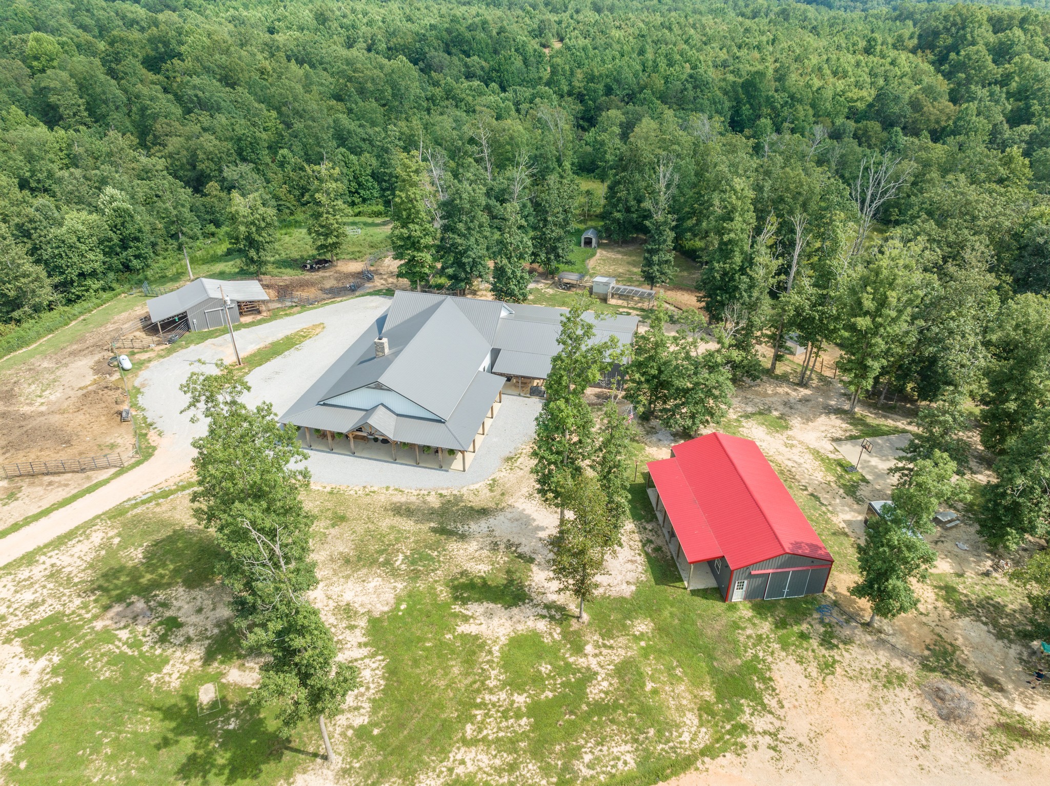 2790 9 Mile Ridge Road Duck River, TN 38454 - Photo 67 of 70 an aerial view of a house with swimming pool and red chairs