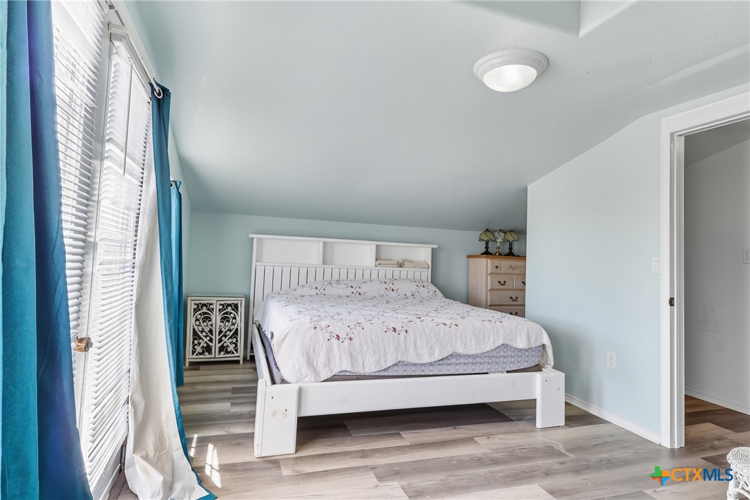 488 Alamo Beach Avenue Port Lavaca, TX 77979 - Photo 20 of 36 a bedroom with a bed and wooden floor