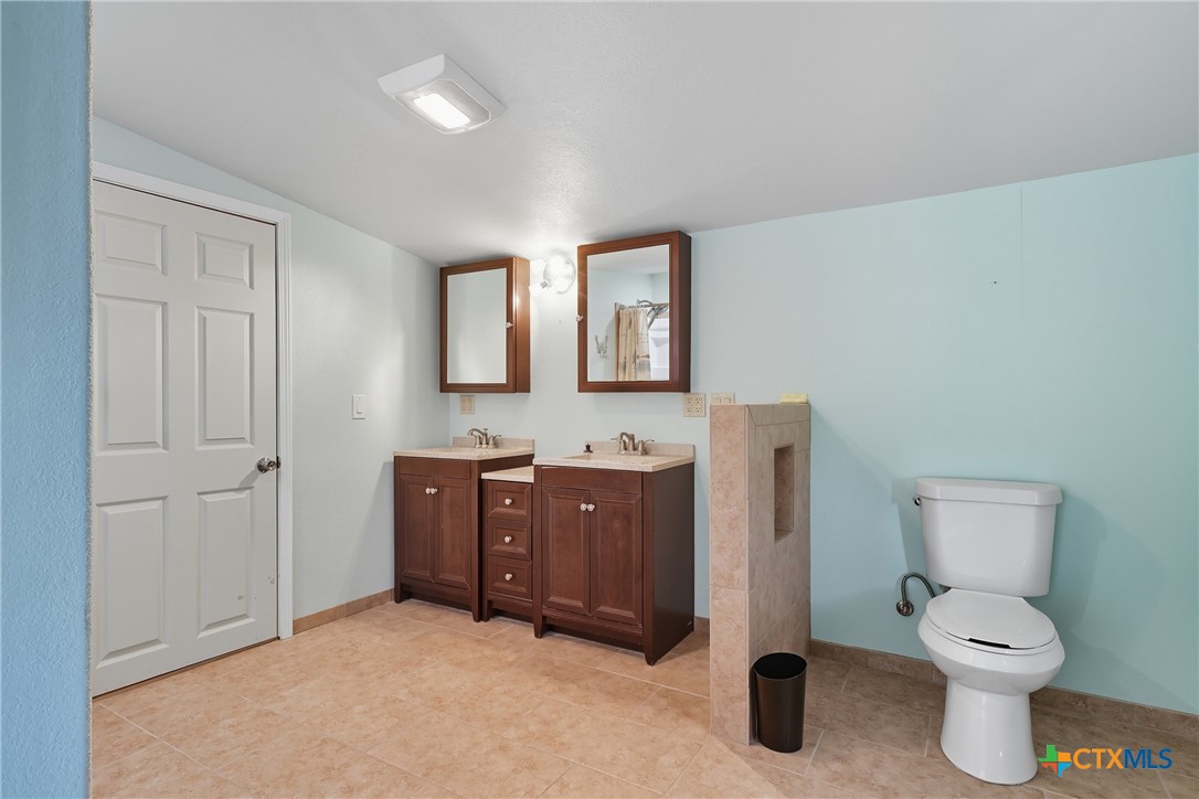 488 Alamo Beach Avenue Port Lavaca, TX 77979 - Photo 21 of 36 a spacious bathroom with a toilet sink and mirror