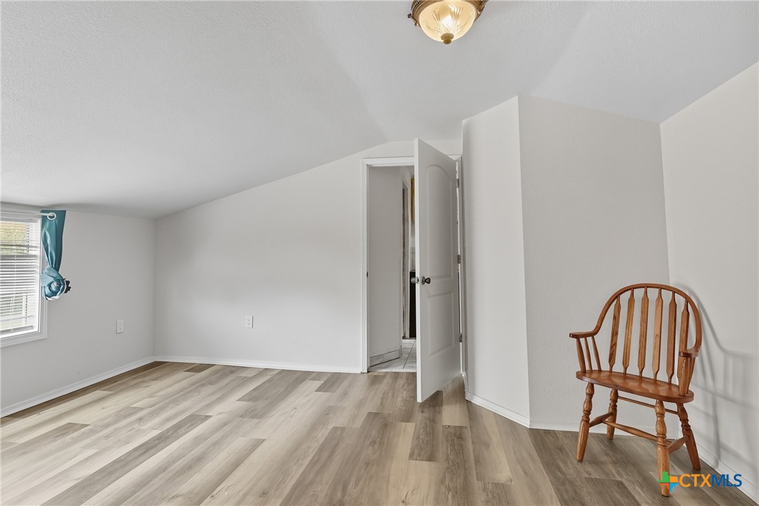 488 Alamo Beach Avenue Port Lavaca, TX 77979 - Photo 23 of 36 a view of wooden floor and chair in a room