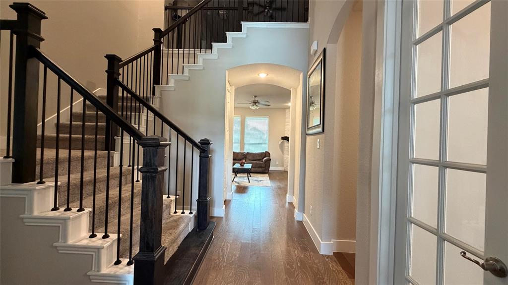 912 Fallbrook Avenue Denton, TX 76210 - Photo 2 of 26 a view of a hallway with wooden floor and staircase