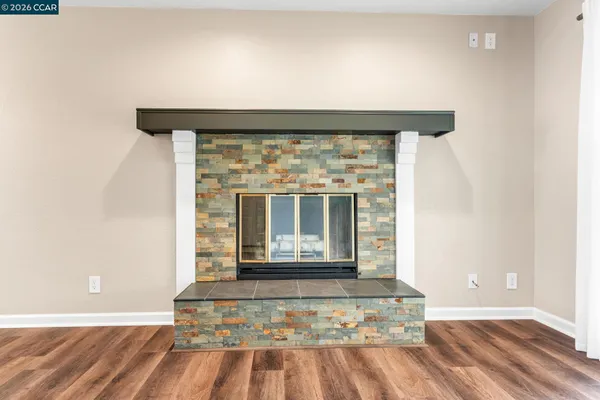 a living room with a fireplace and a floor to ceiling window