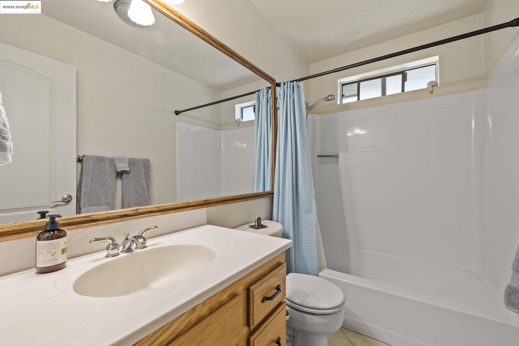 21645 La Vereda Road Sonora, CA 95370 - Photo 17 of 32 a bathroom with a granite countertop sink toilet and shower