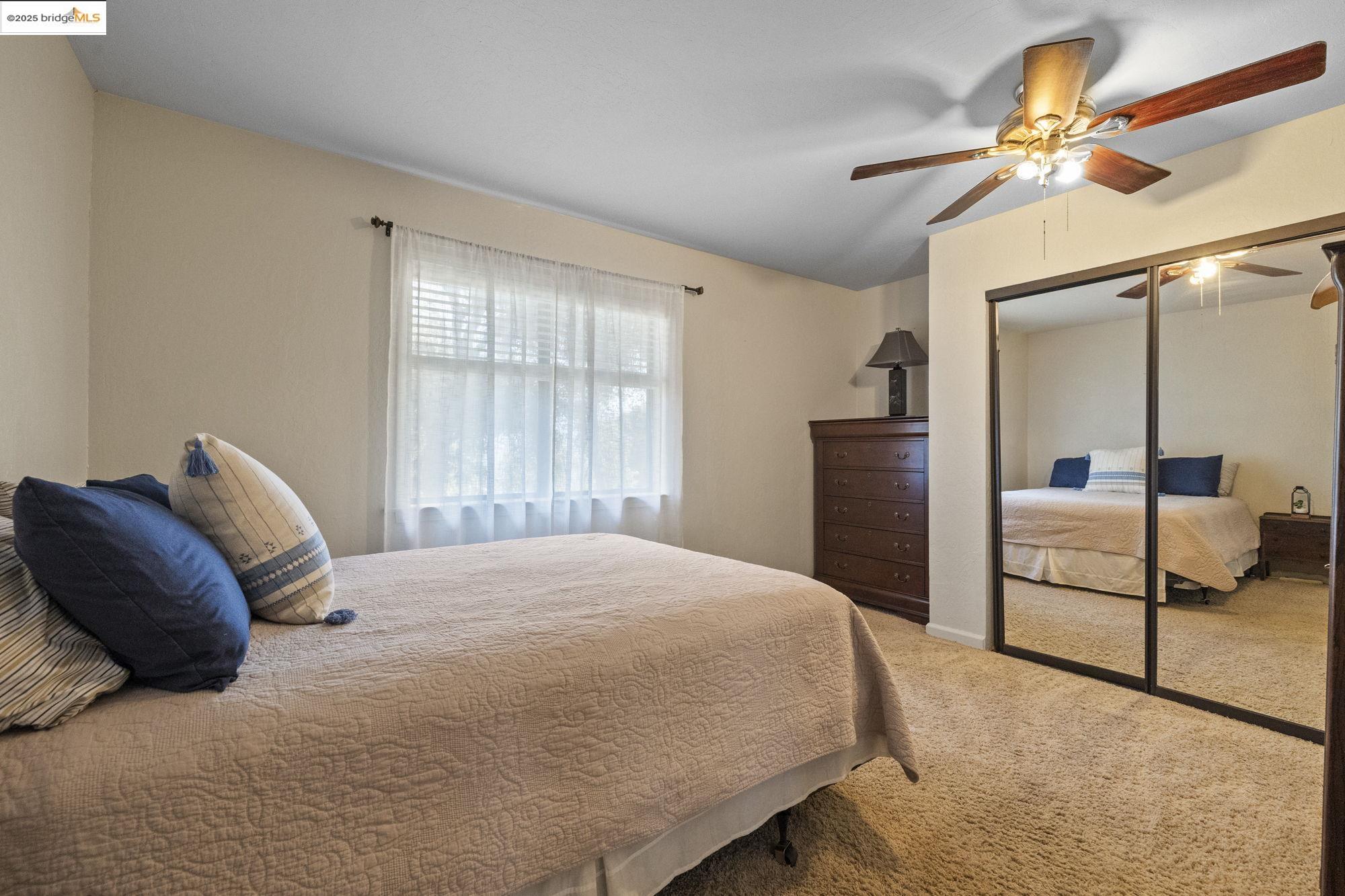 21645 La Vereda Road Sonora, CA 95370 - Photo 18 of 32 a bedroom with a bed and a painting on the wall