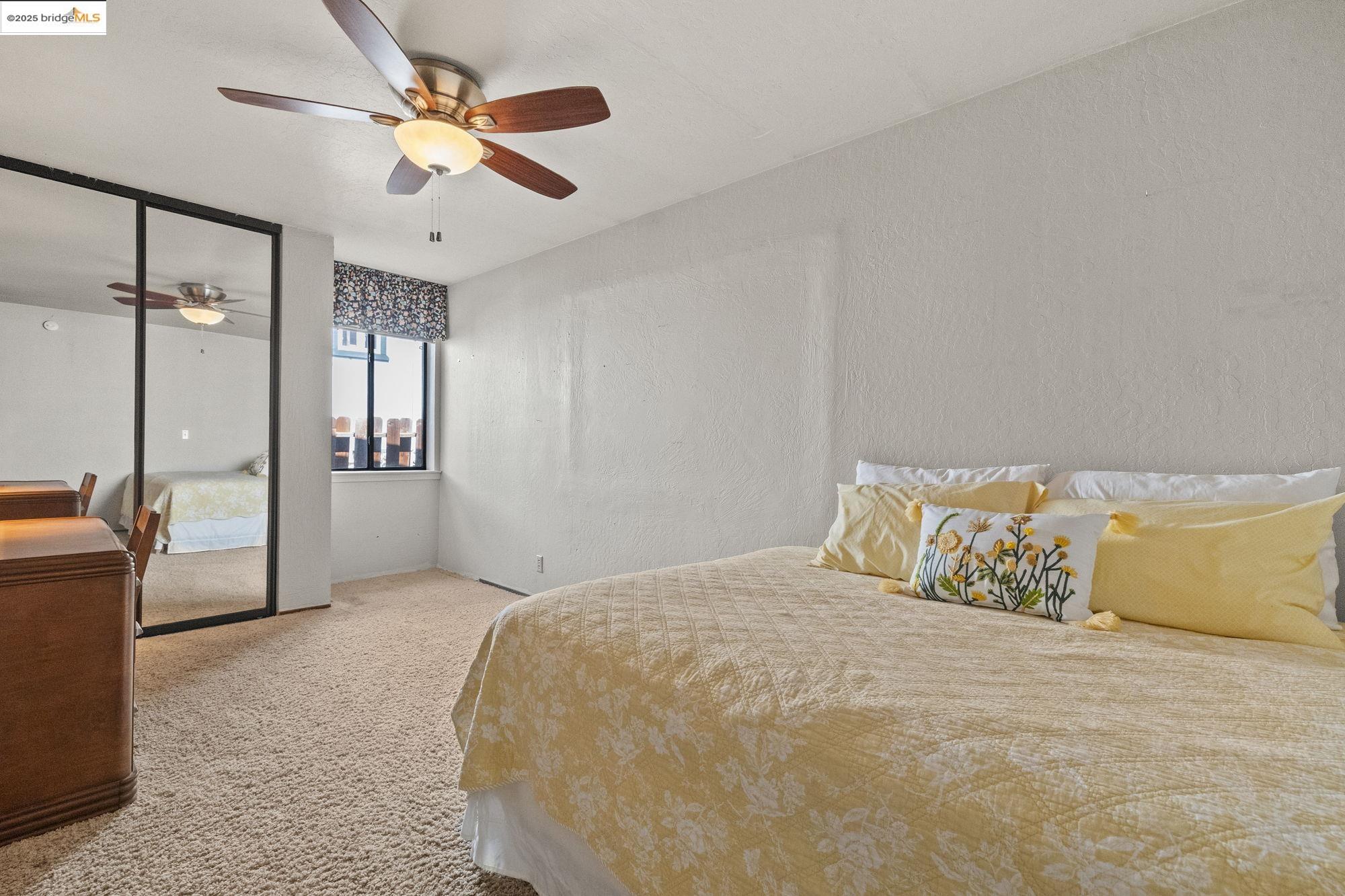 21645 La Vereda Road Sonora, CA 95370 - Photo 19 of 32 a bedroom with a large bed and a chandelier