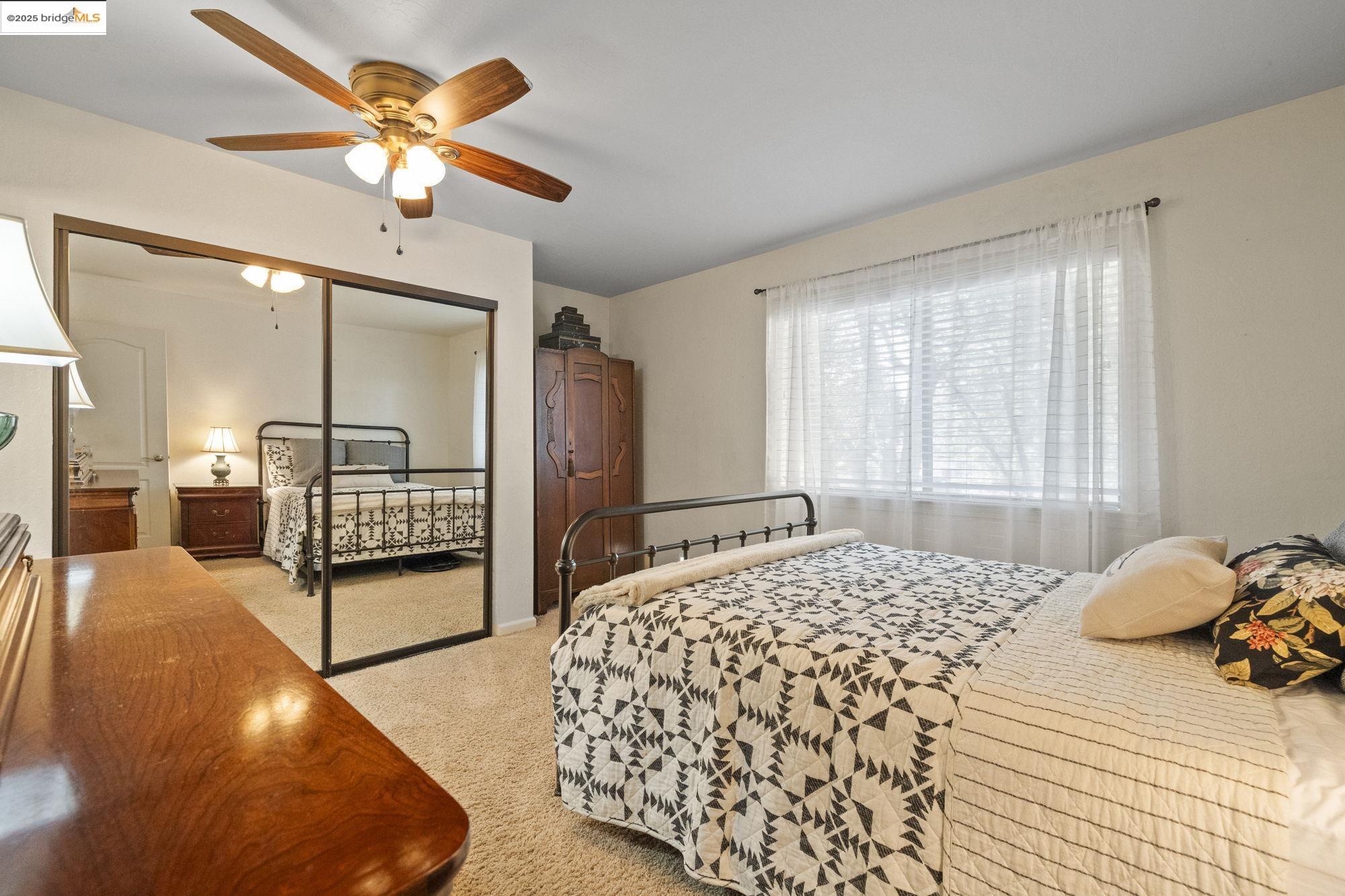 21645 La Vereda Road Sonora, CA 95370 - Photo 20 of 32 a bedroom with a bed and a chandelier