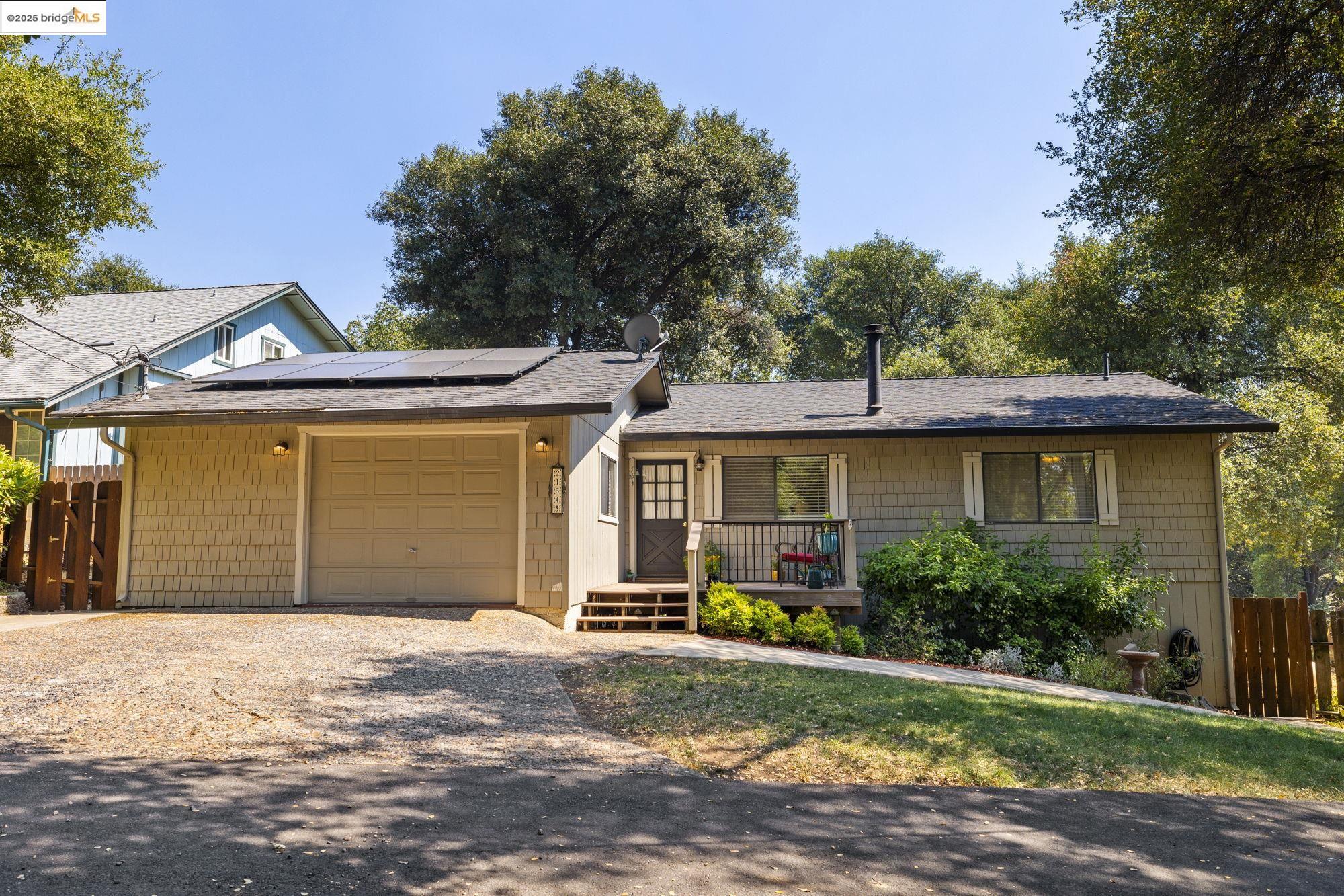 21645 La Vereda Road Sonora, CA 95370 - Photo 2 of 32 a front view of a house with a yard and garage