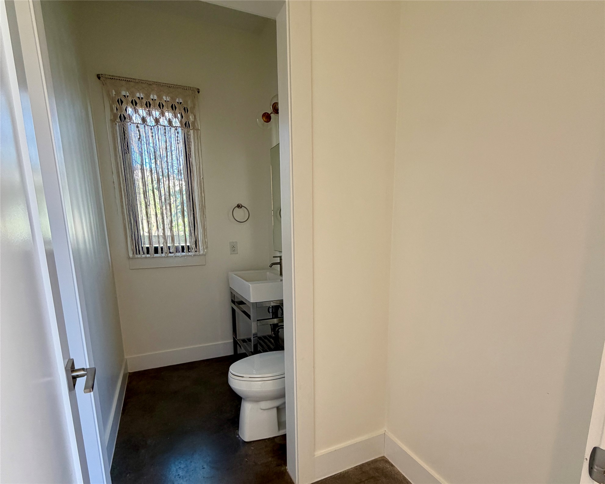 1515 Hether Street, Unit B Austin, TX 78704 - Photo 10 of 30 Minimalist bath features concrete flooring, modern vanity, and a well-lit window.