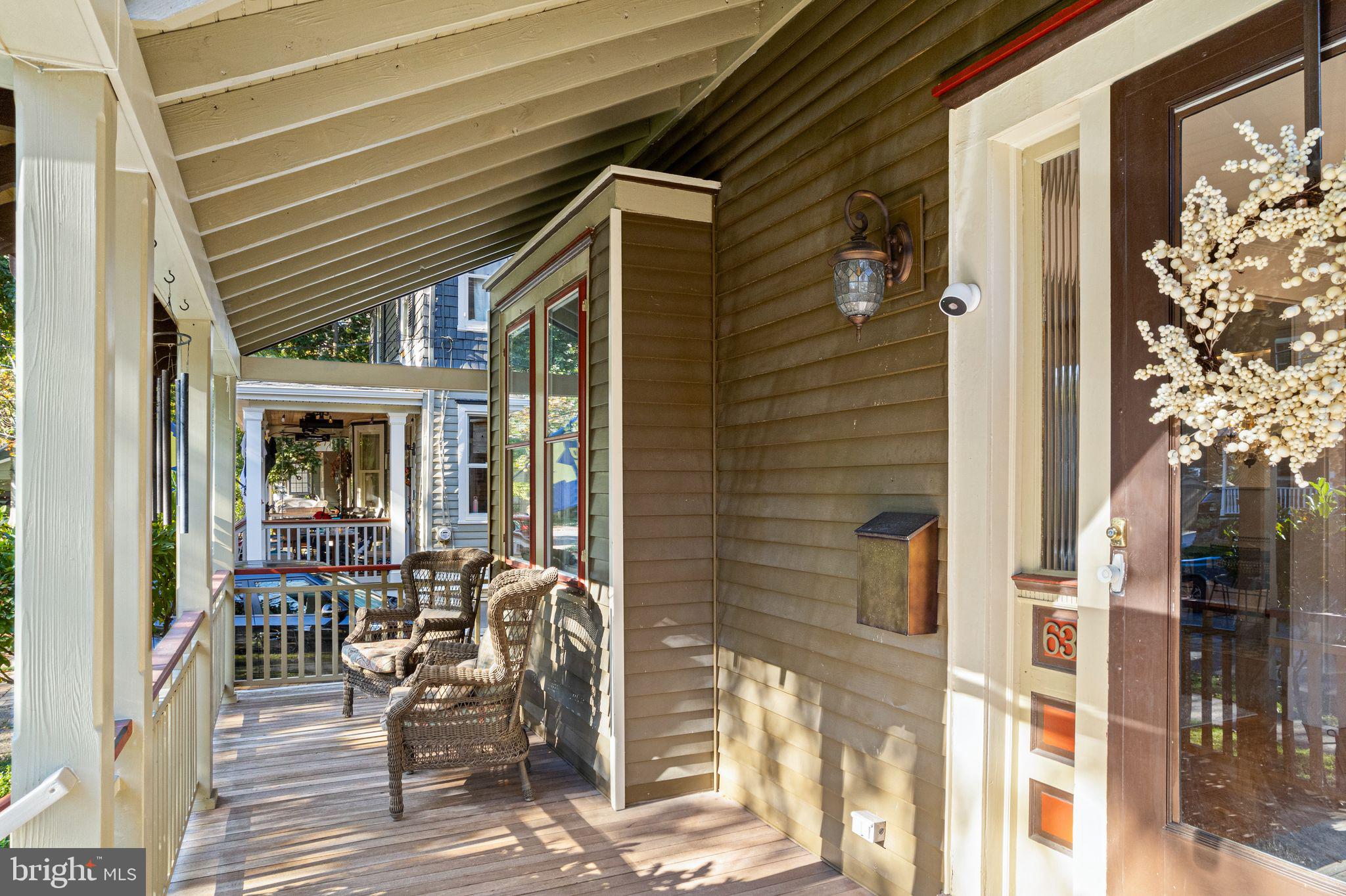 a patio with table and chairs and potted plants