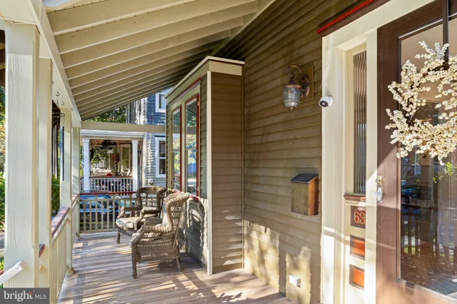 a patio with table and chairs and potted plants