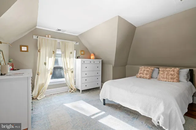 a spacious bedroom with a bed and a cabinets