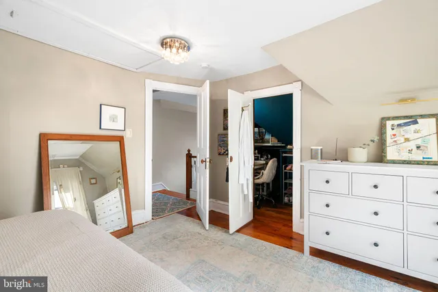 a bedroom with a large bed and a chandelier