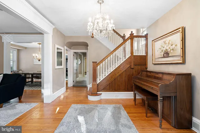 a view of entryway livingroom and hall with wooden floor