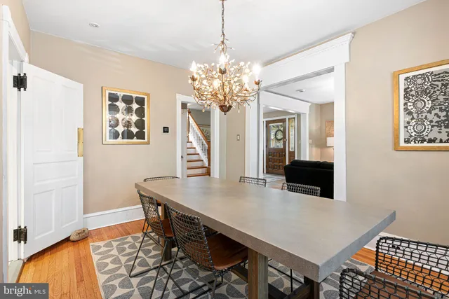 a view of a dining room with furniture and a chandelier