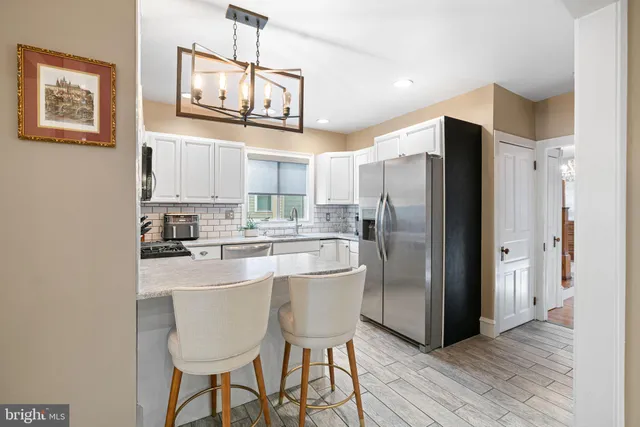 a kitchen with stainless steel appliances granite countertop a refrigerator and a stove top oven