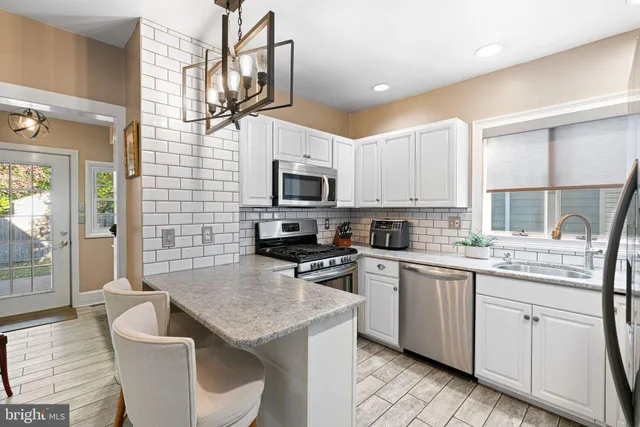 a kitchen with a stove a sink and a microwave