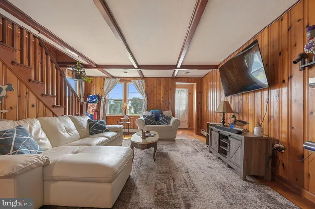 a living room with furniture and a flat screen tv