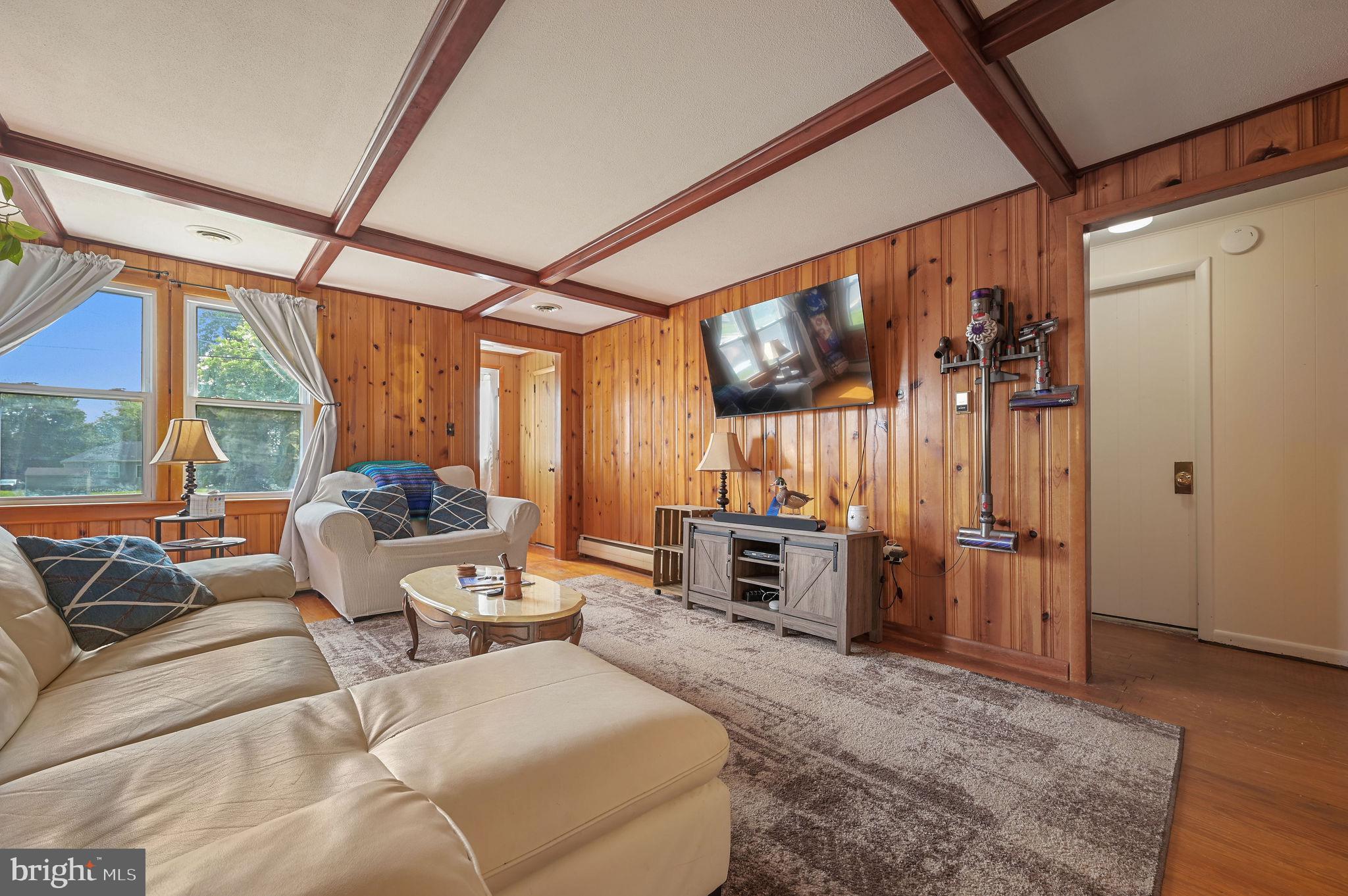 11 Simpson Street Harrington, DE 19952 - Photo 12 of 29 a living room with furniture a flat screen tv and a large window