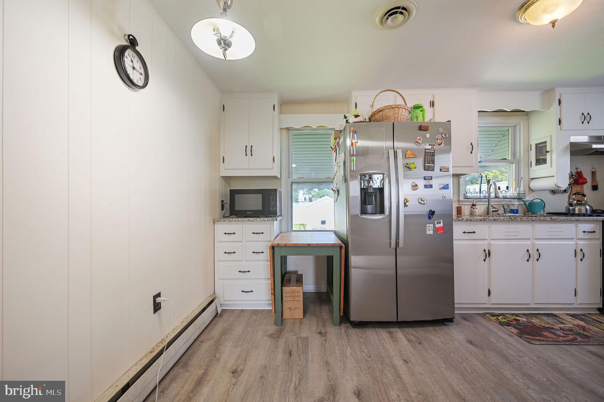 11 Simpson Street Harrington, DE 19952 - Photo 13 of 29 a kitchen with stainless steel appliances a refrigerator sink and stove