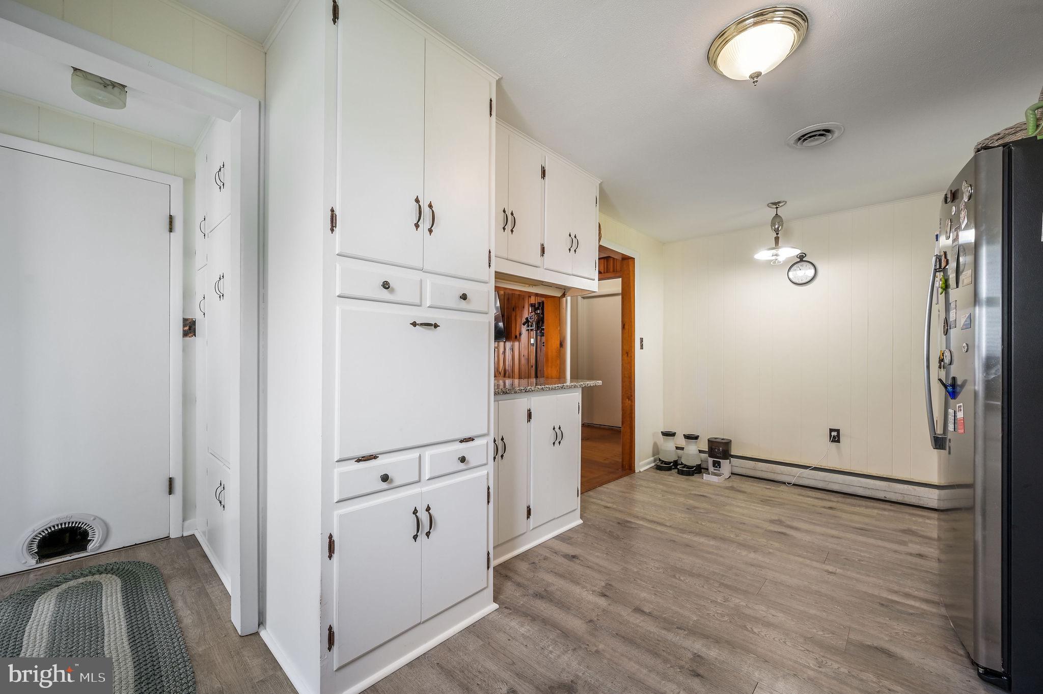 11 Simpson Street Harrington, DE 19952 - Photo 17 of 29 a view of a kitchen with refrigerator stove and wooden floor
