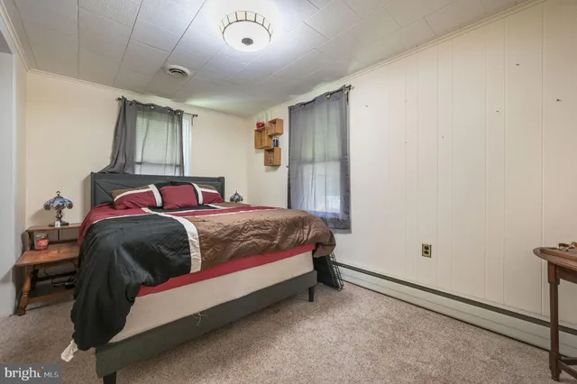 a bedroom with a bed and window