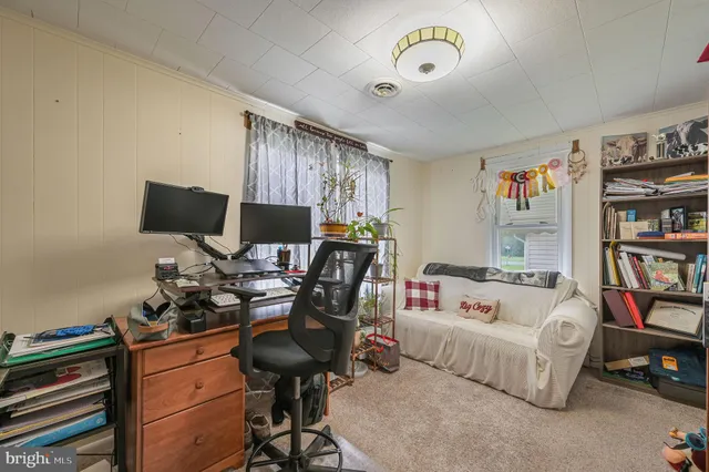 a bedroom with furniture and a book shelf