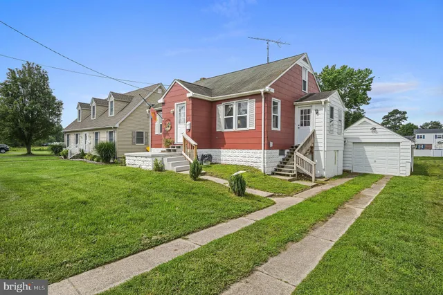 a front view of house with yard and green space