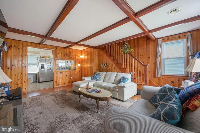 a living room with furniture a rug and a large window