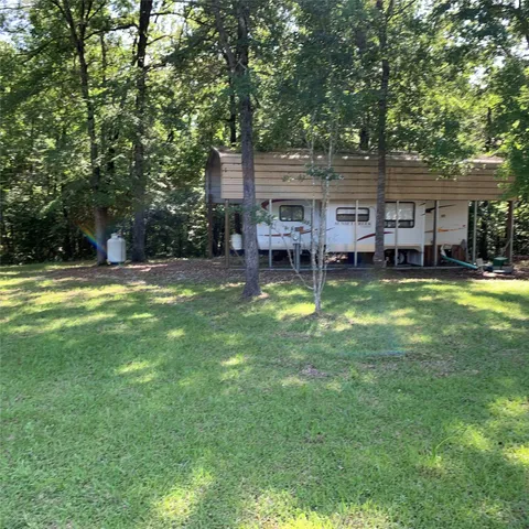 a view of a house with a swimming pool and a big yard
