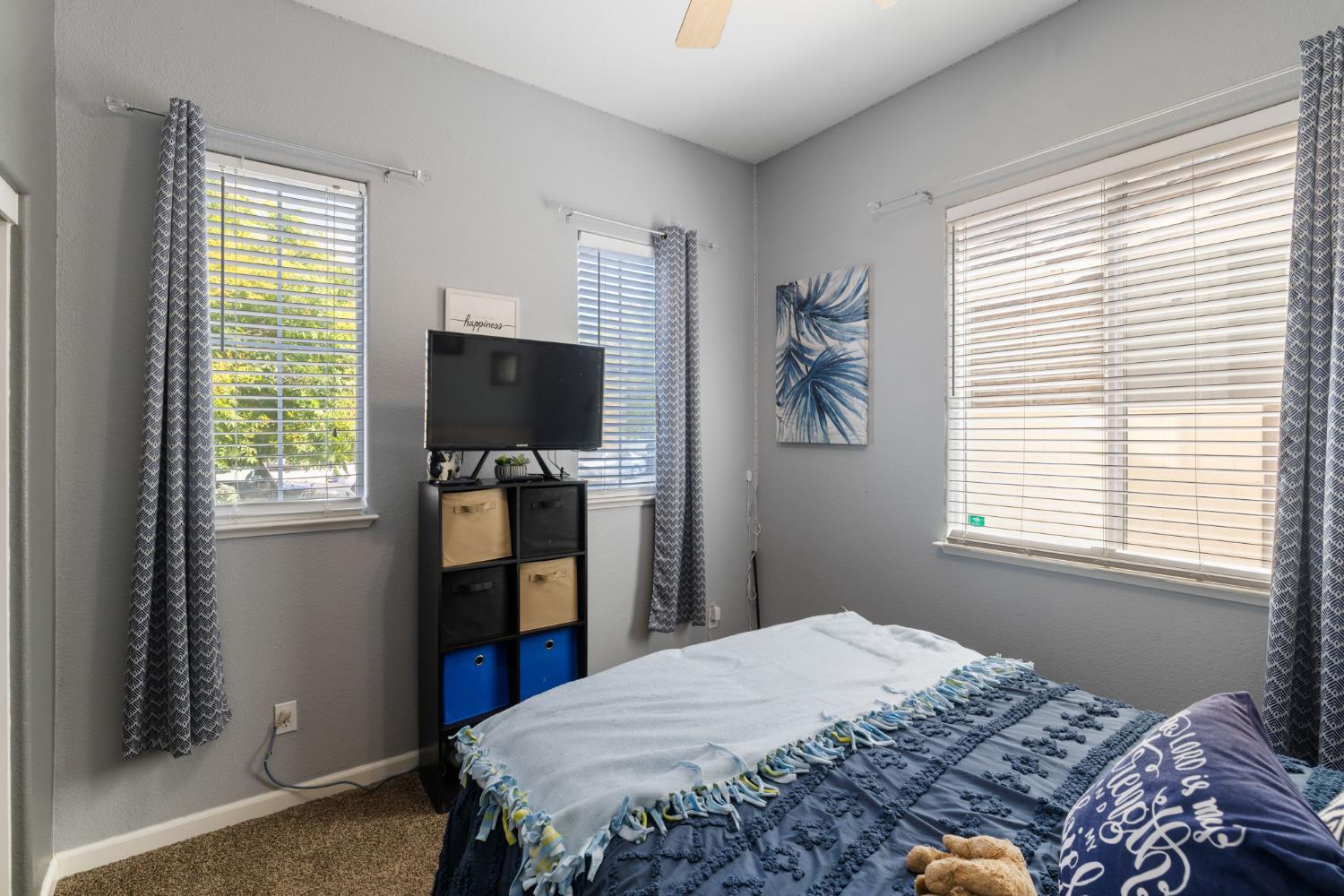 562 Ranger Street Oakdale, CA 95361 - Photo 13 of 64 Downstairs bedroom featuring carpet flooring and a ceiling fan