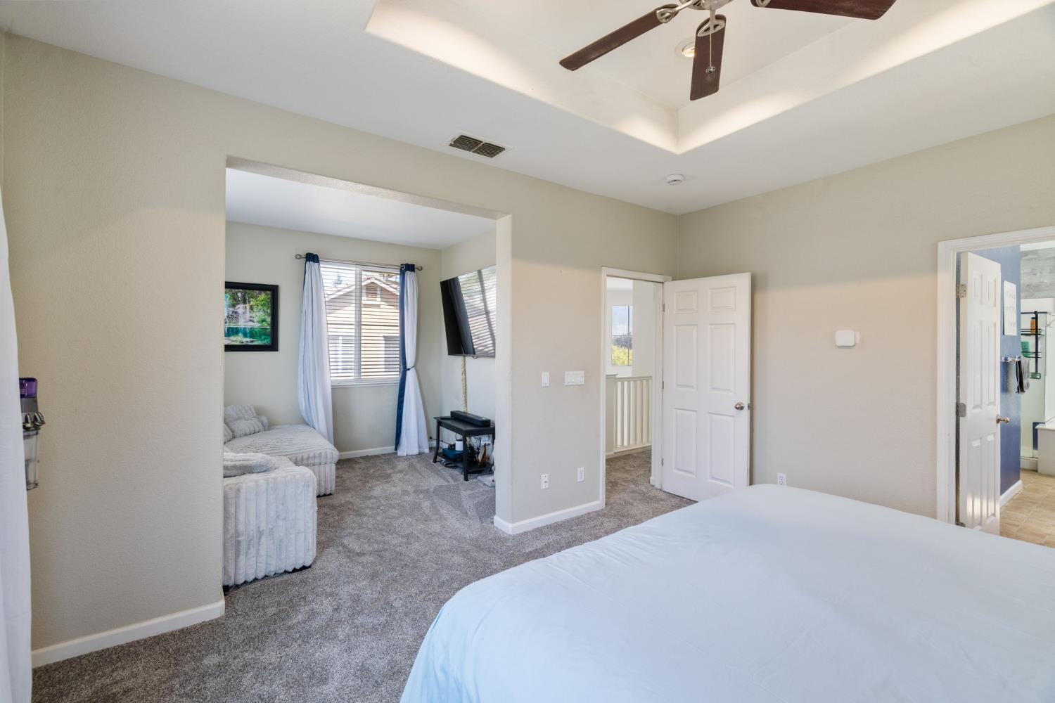 562 Ranger Street Oakdale, CA 95361 - Photo 31 of 64 Master bedroom with seating room, raised ceiling with fan and cam lights