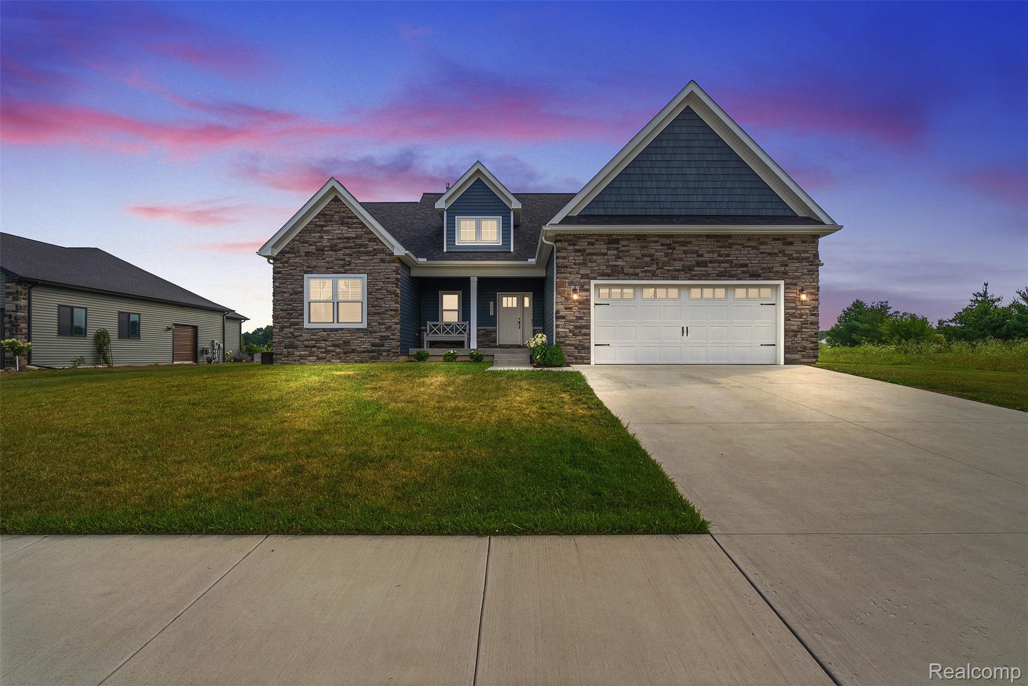 9087 Copper Ridge Drive Davison, MI 48423 - Photo 2 of 46 Stone and siding exterior featuring a prominent gable roofline