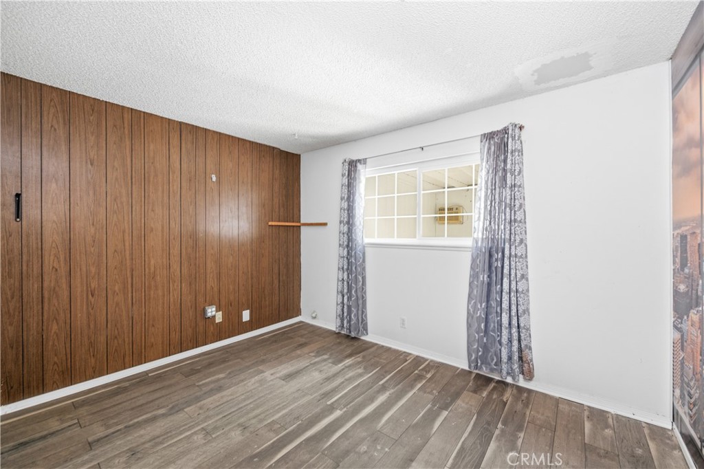 2490 Invar Court Simi Valley, CA 93065 - Photo 14 of 25 an empty room with wooden floor and windows