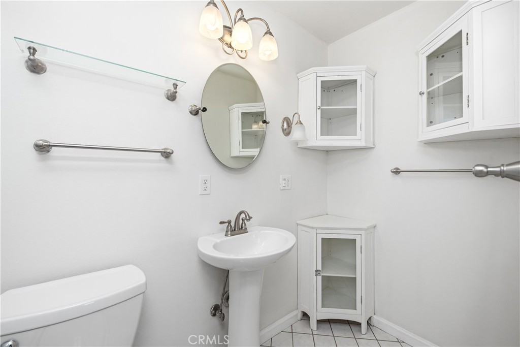 2490 Invar Court Simi Valley, CA 93065 - Photo 18 of 25 a bathroom with a toilet sink and mirror