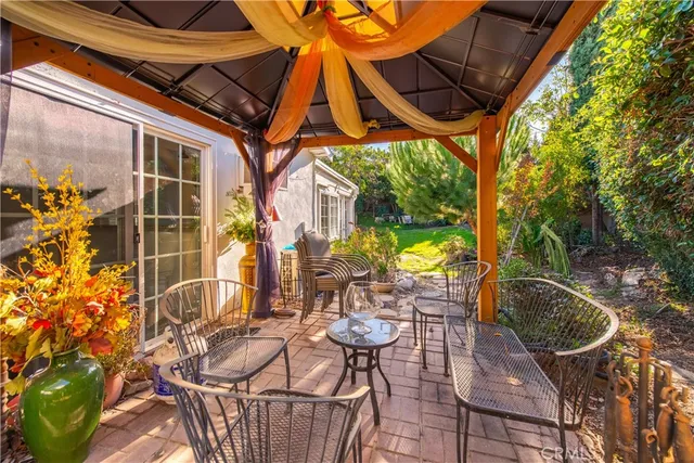 a backyard of a house with table and chairs