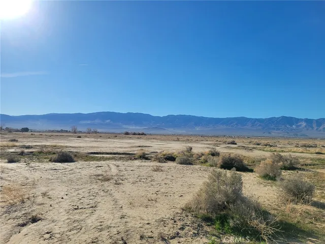 a view of an ocean beach and mountain