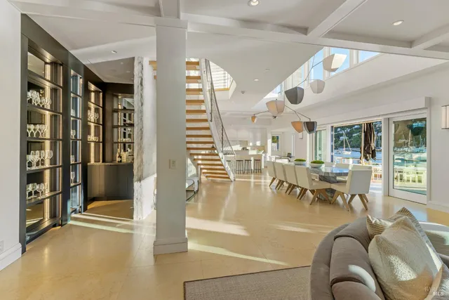 a living room with fireplace furniture and a large window