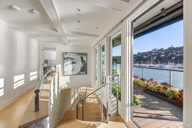 a living room with furniture and floor to ceiling windows