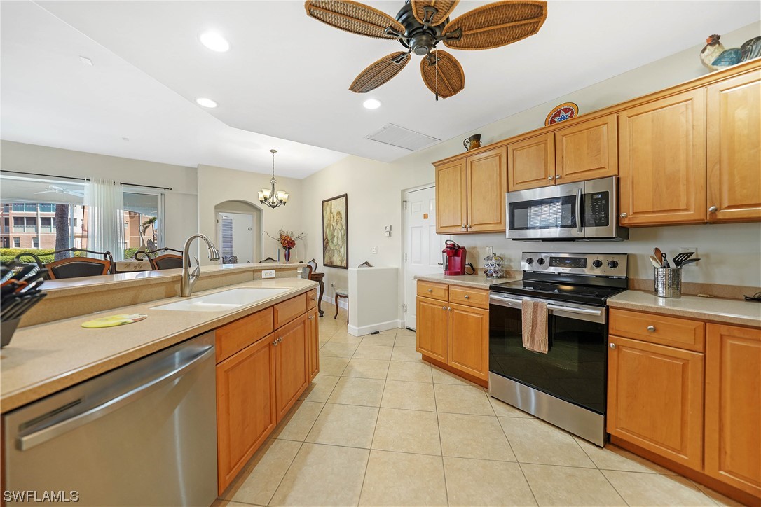 3228 Sunset Key Circle, Unit 101 Punta Gorda, FL 33955 - Photo 15 of 33 a kitchen with stainless steel appliances granite countertop a sink and cabinets