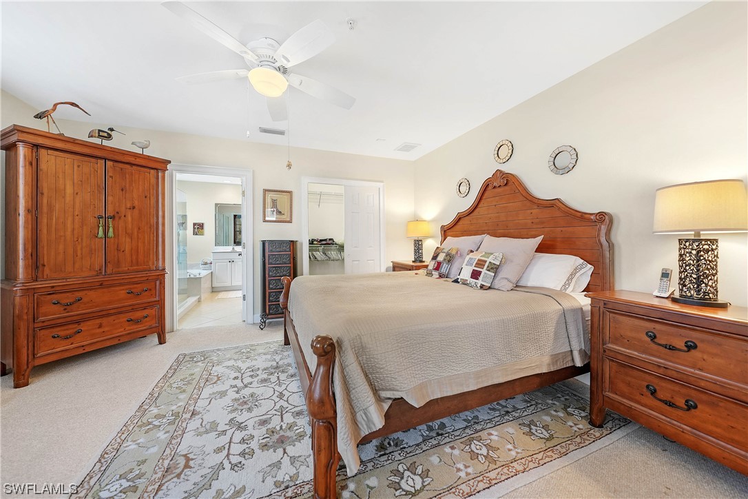3228 Sunset Key Circle, Unit 101 Punta Gorda, FL 33955 - Photo 16 of 33 a bedroom with a bed and a dresser in it