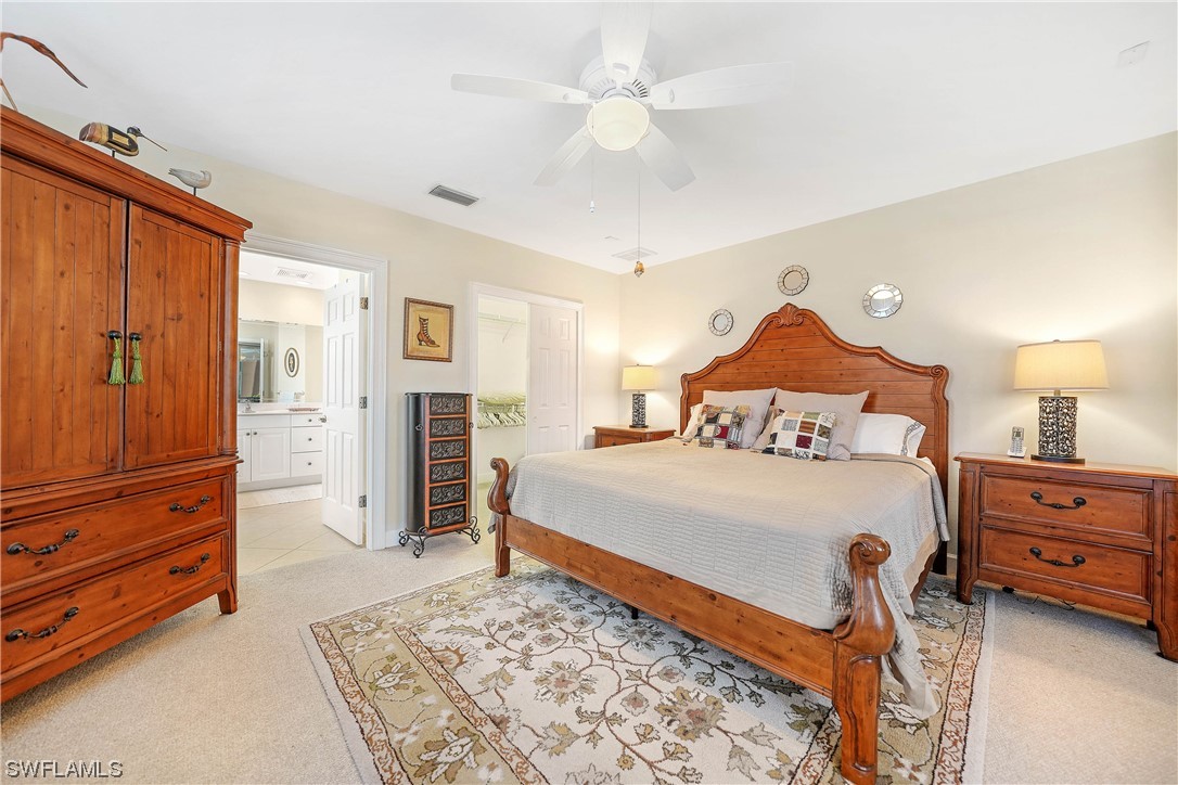 3228 Sunset Key Circle, Unit 101 Punta Gorda, FL 33955 - Photo 17 of 33 a bedroom with a bed and a dresser